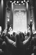 hands raised in worship at a worship service 