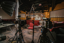 Lights and cameras on church documentary set.