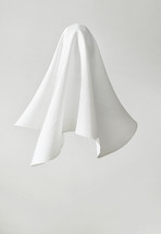 White fabric in shape of a ghost on white background