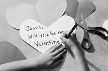 A little girl drawing a Valentine's day card for Jesus 