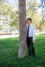 portrait of a boy in dress clothes outdoors 