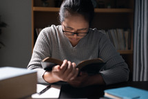 Woman praying with a Bible