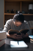 Woman praying with a Bible