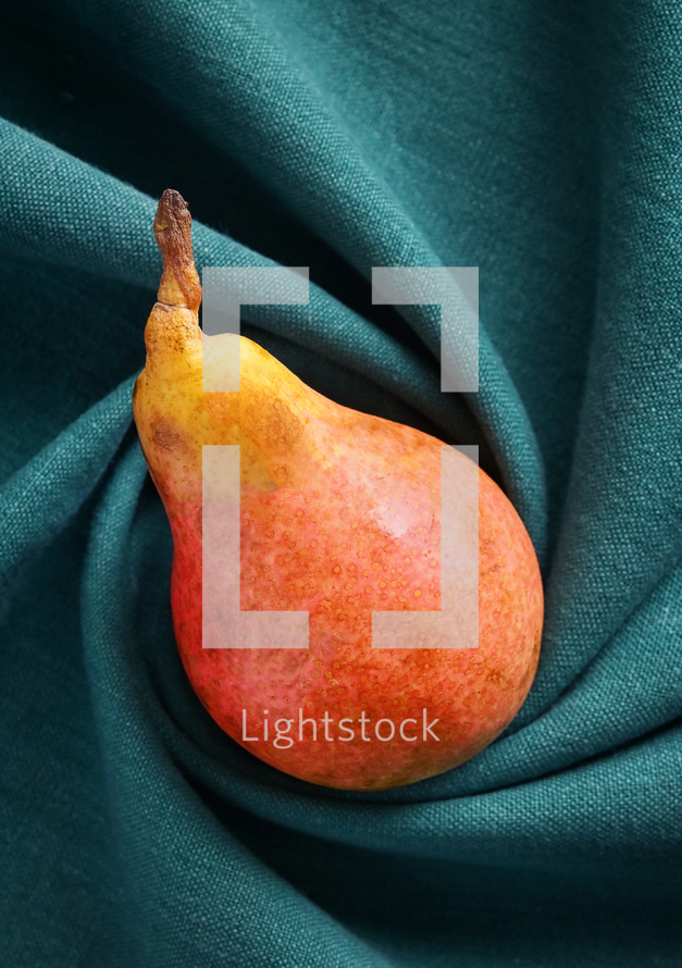 Abstract of One Pear on Swirled Cloth Background
