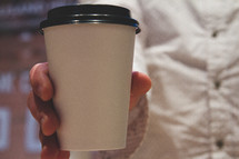 man holding a coffee cup 