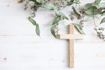 Cross and branches with green leaves