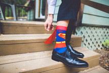 A man wearing Superman socks. 
