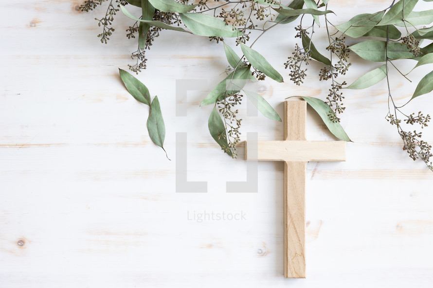 Cross and branches with green leaves