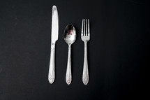 silverware on a black background 