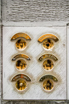 brass door buzzers on a building in Venice 