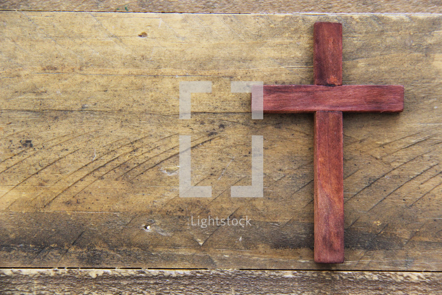 wooden cross on a wood background