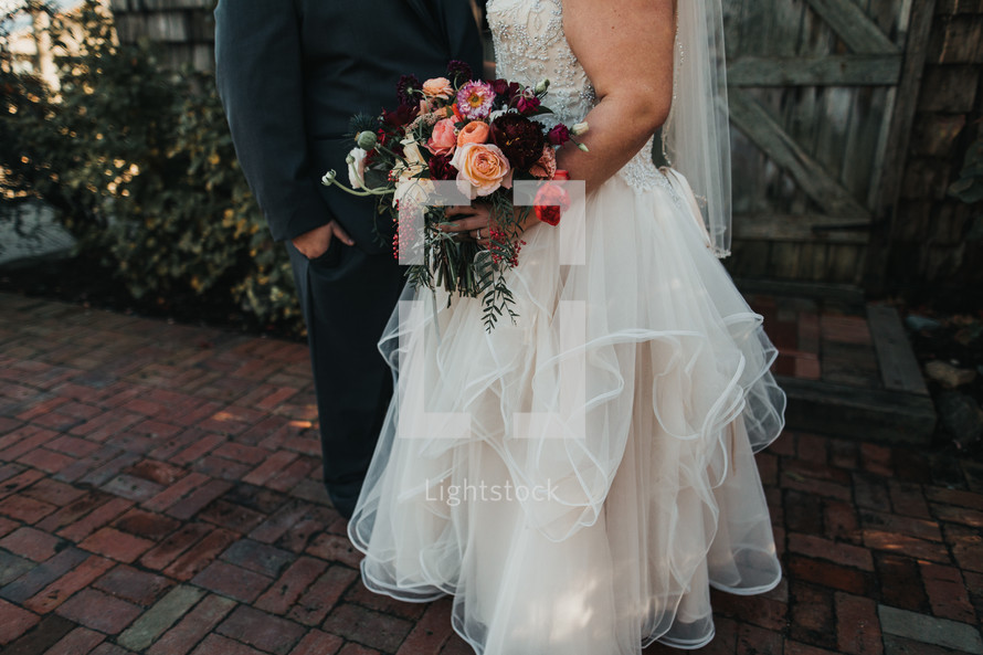 bride with her bouquet and groom 