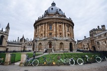 bikes parked against a fence and domed building 