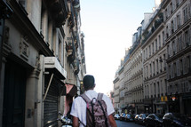 man walking down Paris streets 