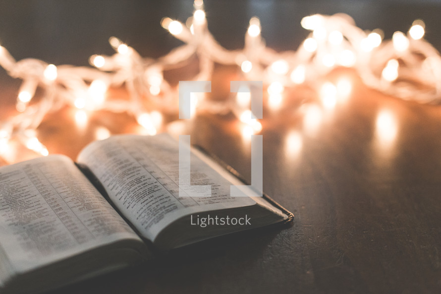 white Christmas lights and open Bible 