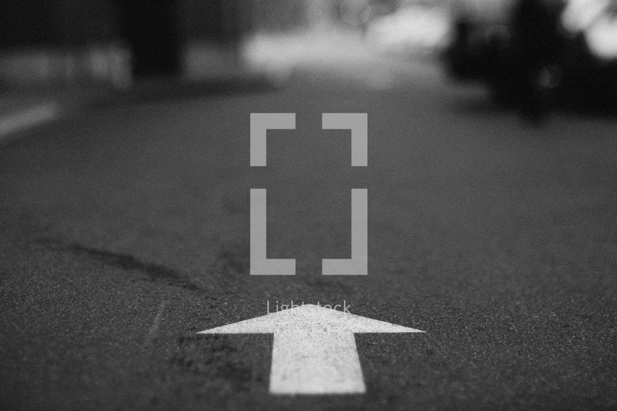 arrow pointing down a road 