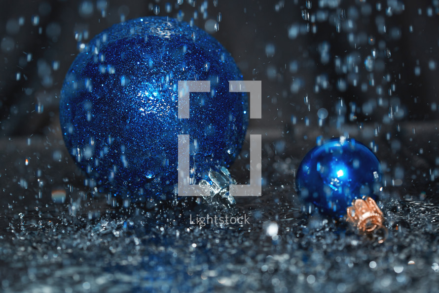 blue Christmas ornaments in rain 