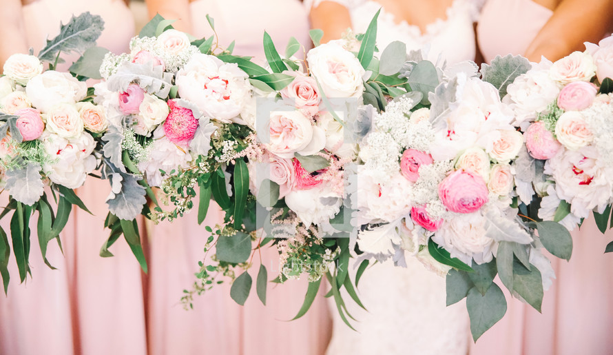 bridesmaids and bride holding bouquets 