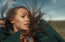 a woman's hair blowing in the wind 