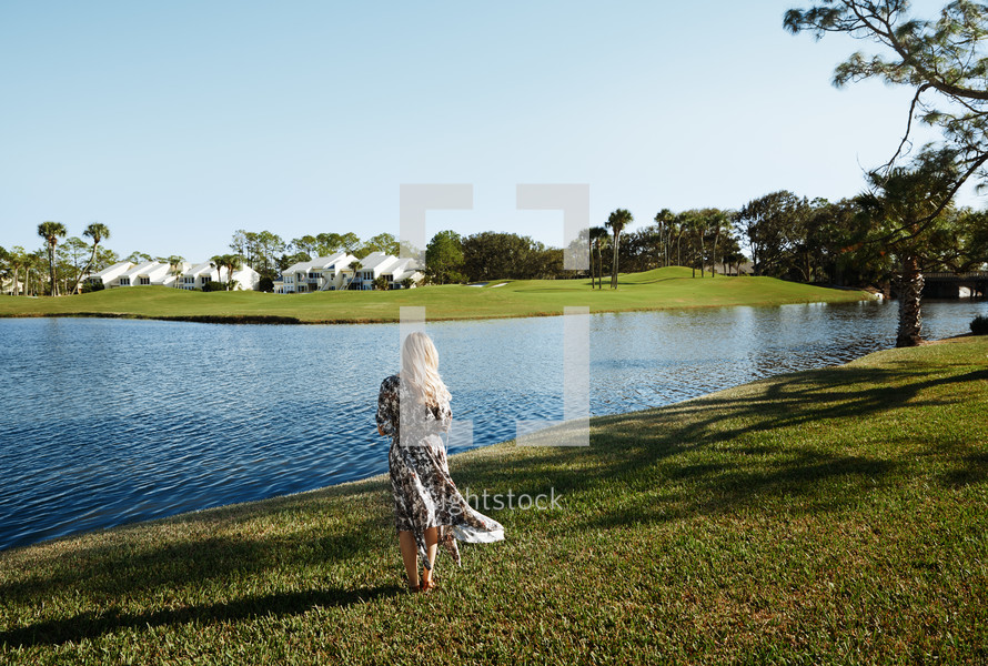 woman standing at the edge of a lake in Florida 