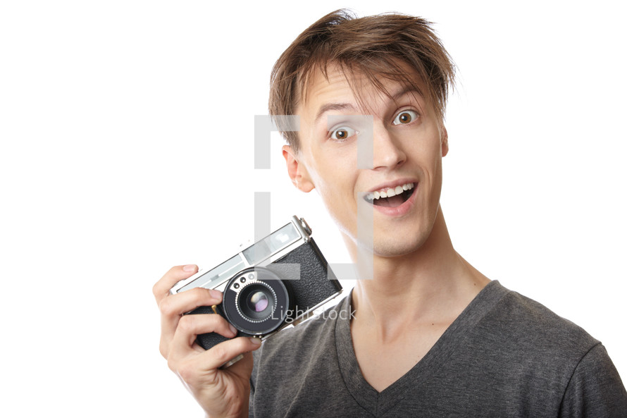 a happy man holding a camera 