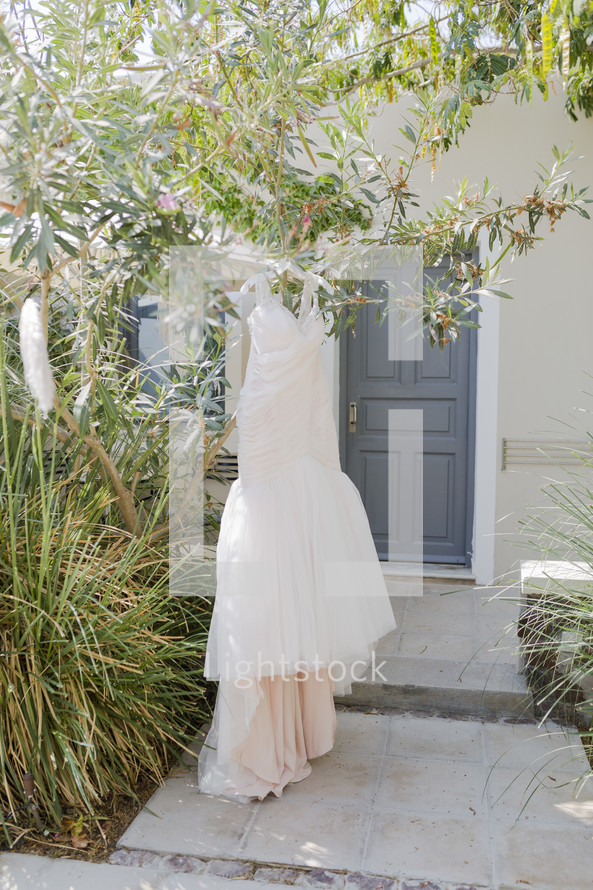 wedding gown hanging outdoors 