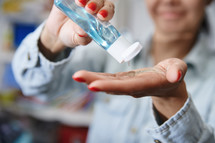 woman using hand sanitizer 