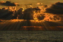 rays of sunlight through the clouds over the ocean 