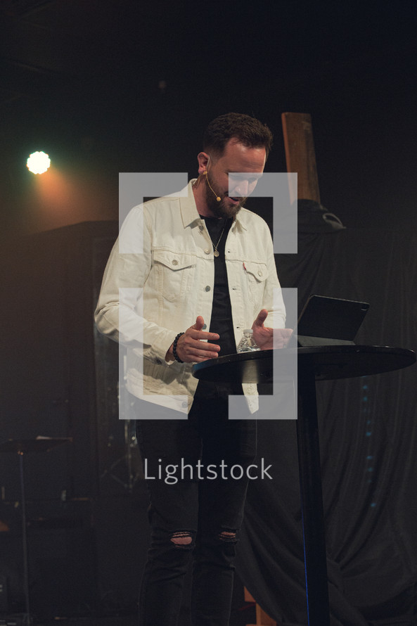 minister on stage during a contemporary worship service 