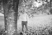 a toddler girl playing outdoors in fall 