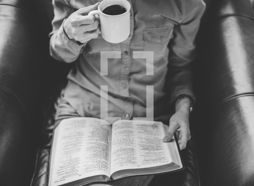 A woman drinking coffee and reading a Bible 