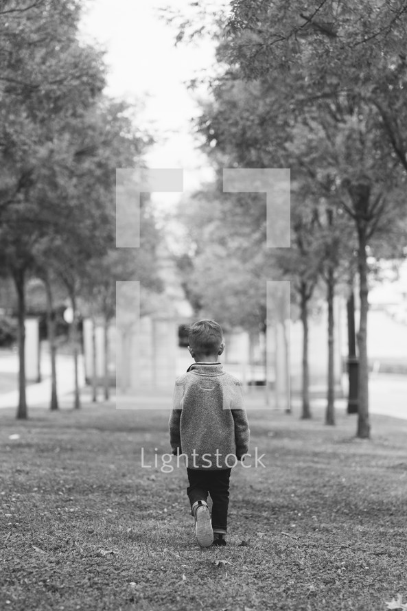 a boy walking in a park 