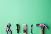 Tools on a green background.