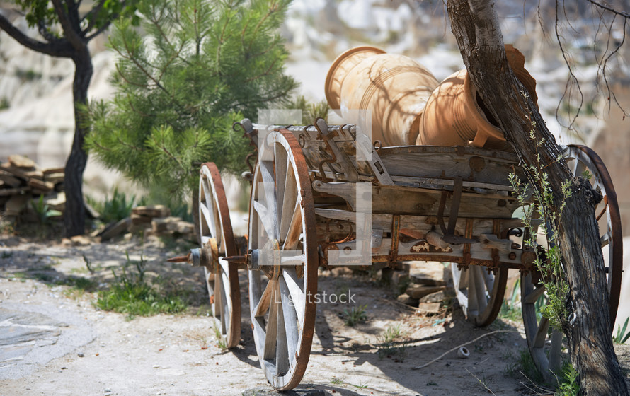 Ancient wooden wheeled wagon with pots