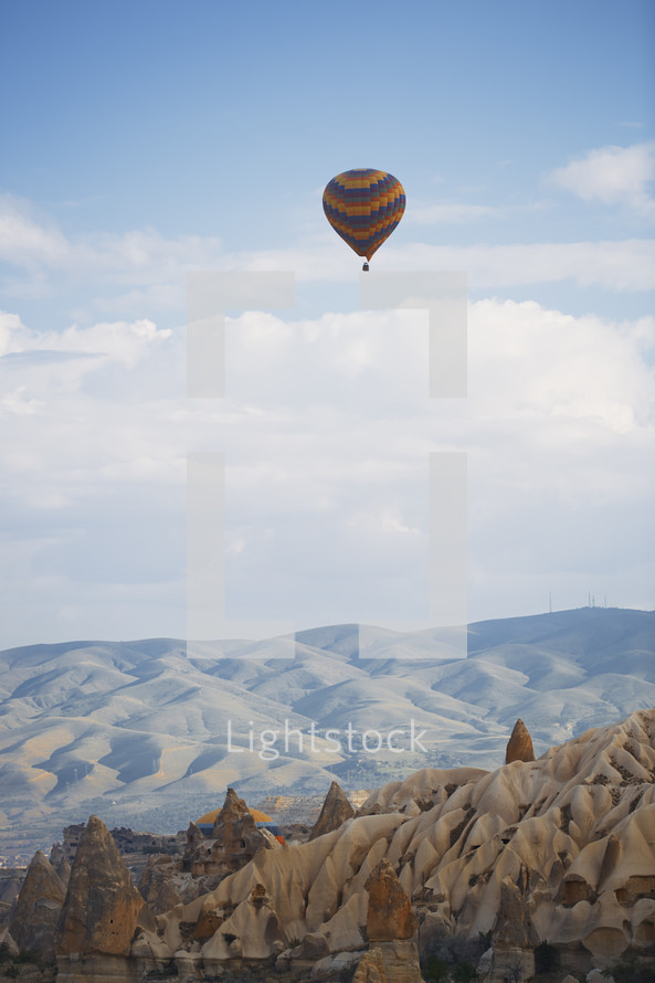 hot air balloons over desert canyon 