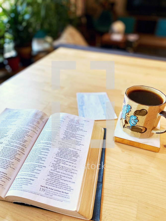 coffee mug and Bible on a table 