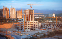 construction cranes on city buildings 
