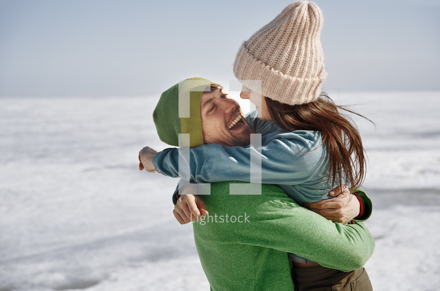 couple hugging in snow 