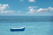 A small boat floating in a calm sea.