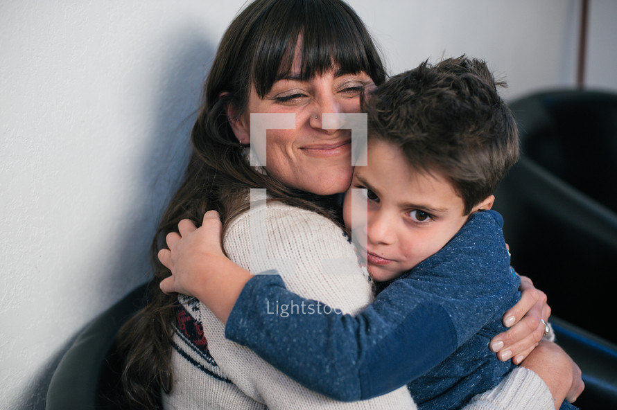 mother hugging her son 