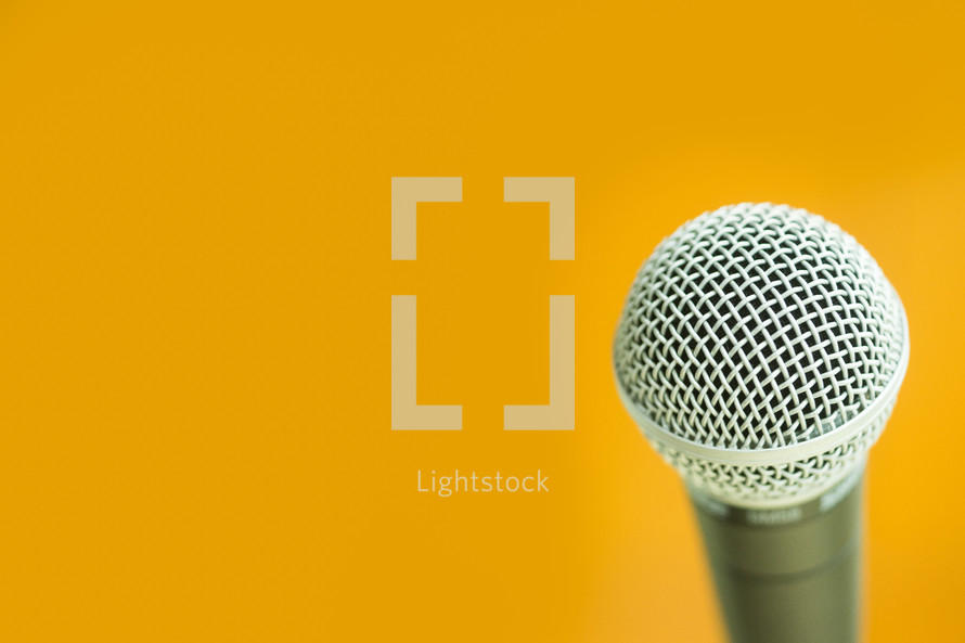microphone against a yellow background 