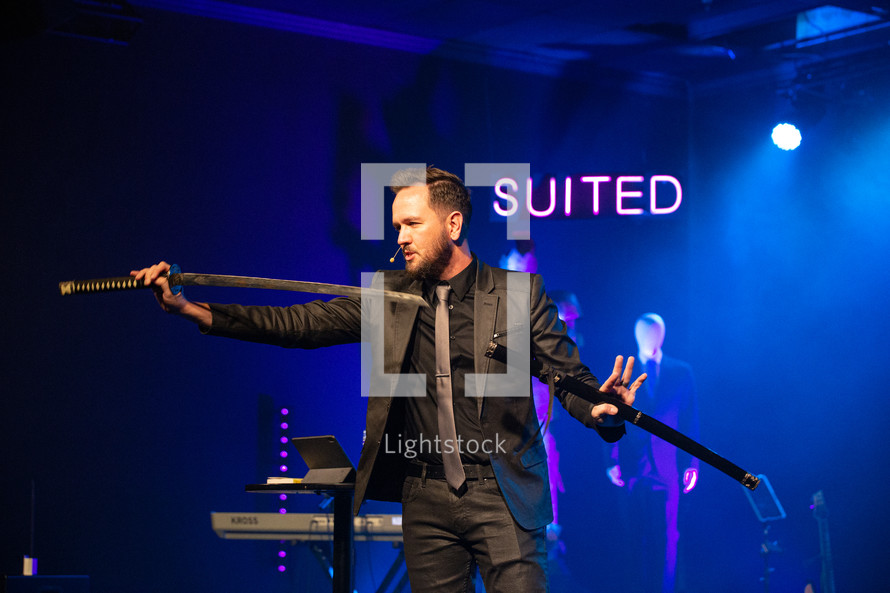 a minister holding a sword during a worship service 
