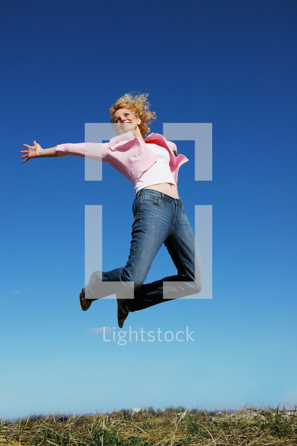 a woman jumping up in the air celebrating 
