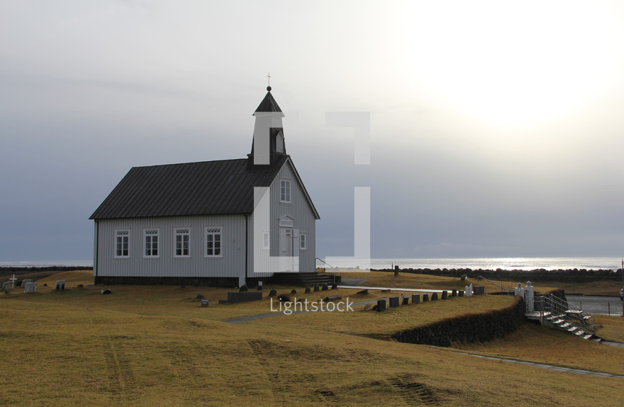 Simple church building along a remote shore 