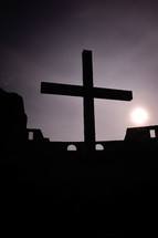 silhouette of a cross on a rooftop 
