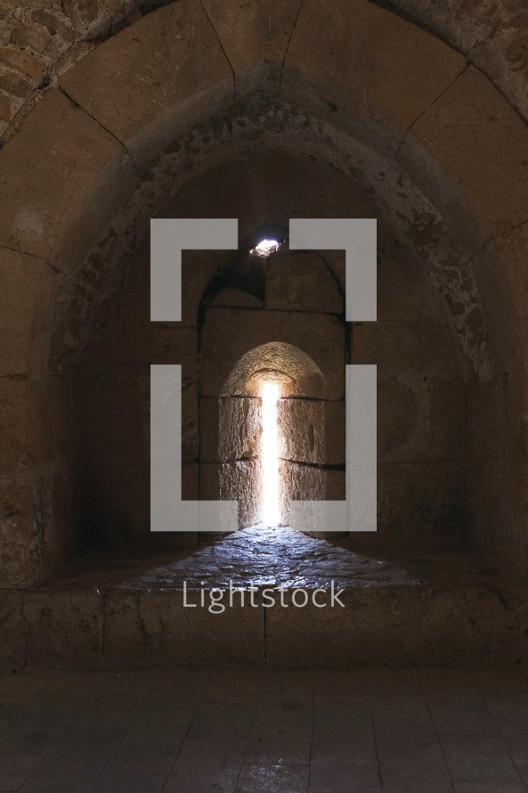 sunlight through a window in ruins at an historic site in Jordan 