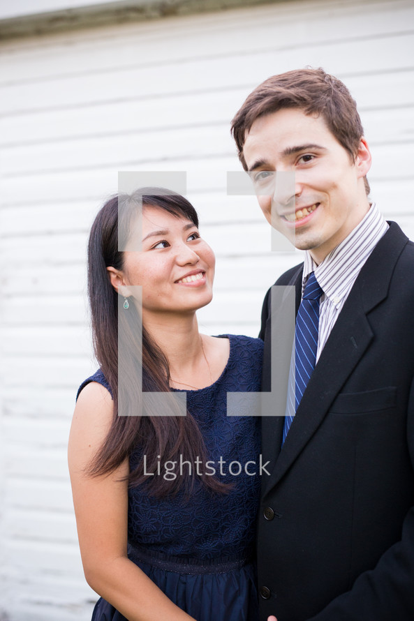a man and woman in dress clothes 