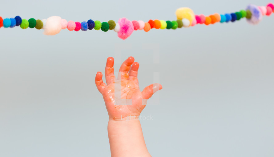 a sticky infant hand reaching for a banner 