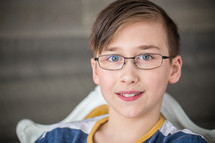 face of a boy in glasses 