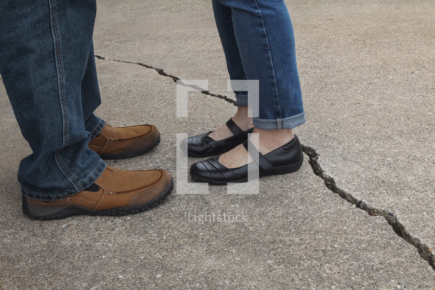 couple standing next to a crack 